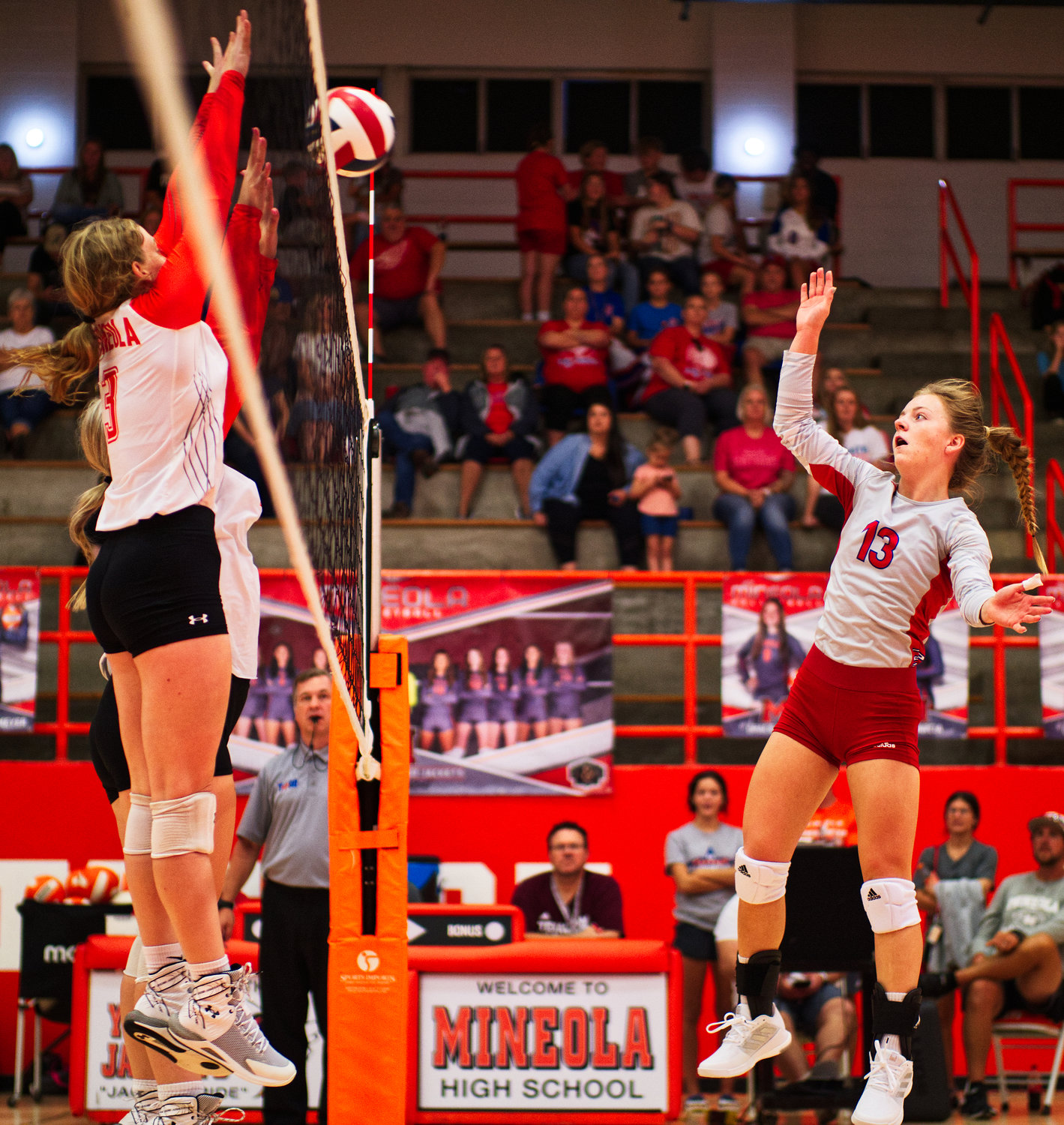 Alba-Golden’s Cacie Lennon hits over Mylee Fischer and Jocelyn Whitehead of Mineola. [view more volleyball shots]